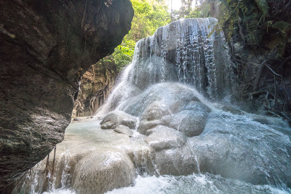 View of limestone rocks and a waterfall flowing at Level 3 of Aguinid Falls, Cebu
