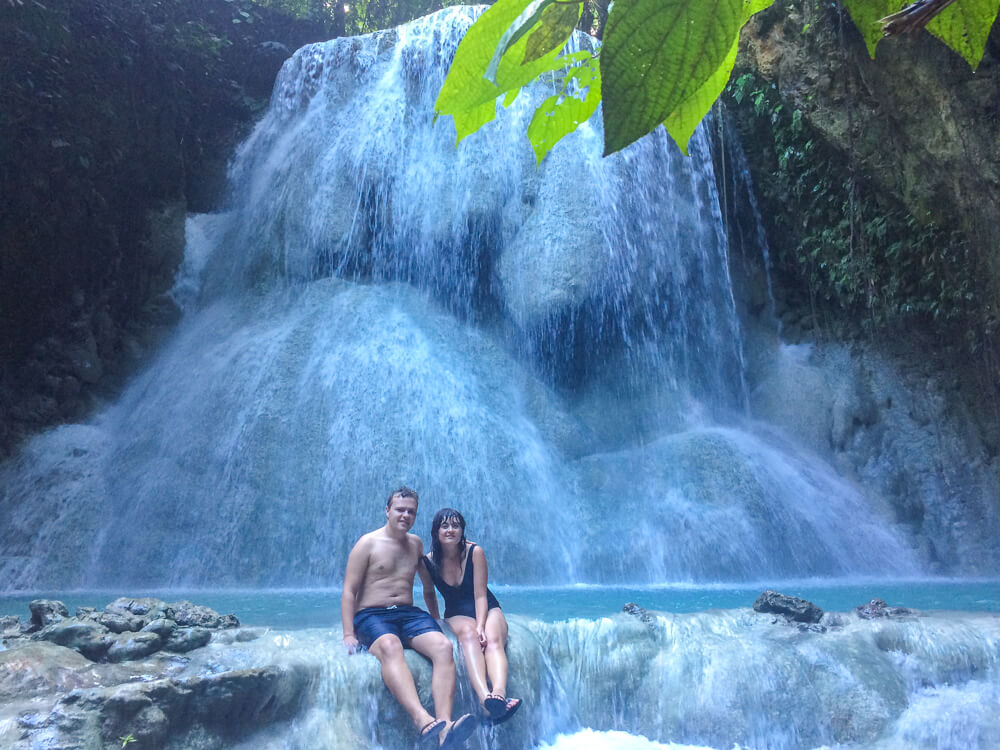 Sat in front of the flowing waterfall at Level 5 of Aguinid Falls